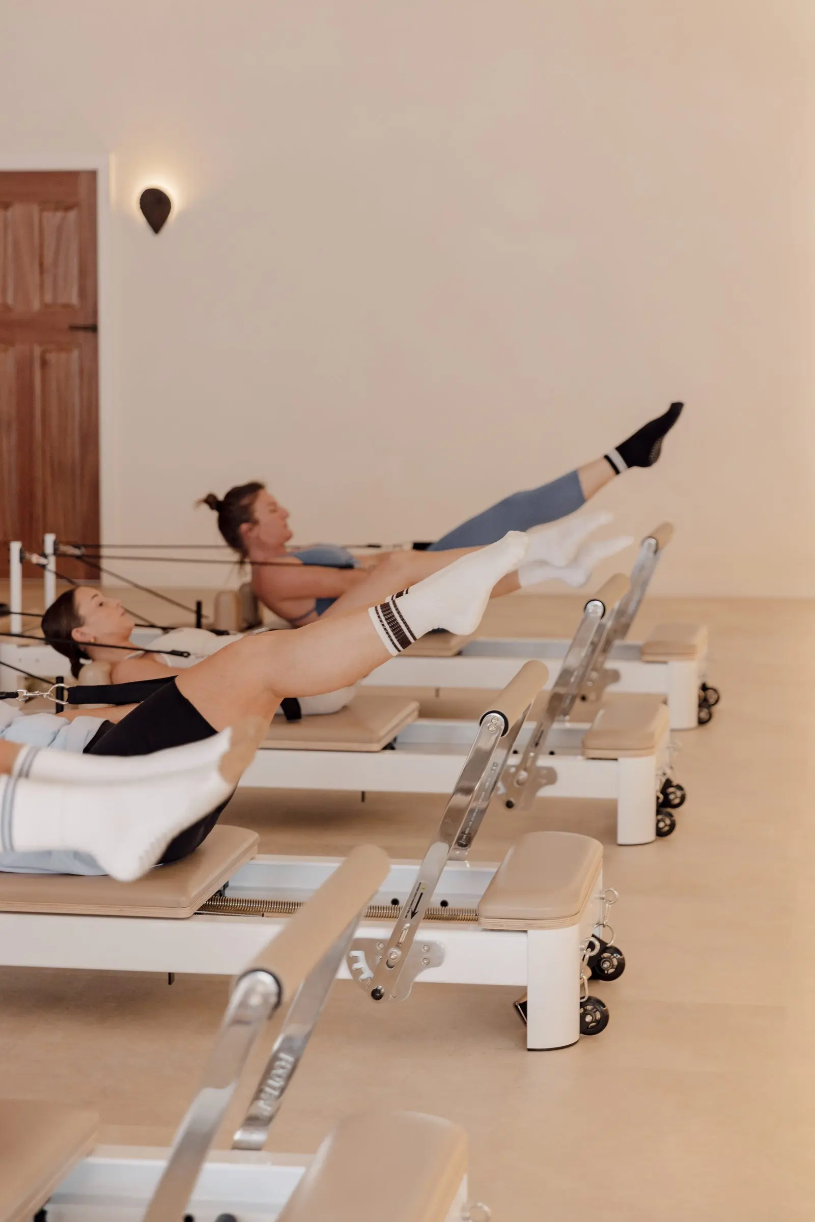 A member pressing through a leg exercise on the reformer