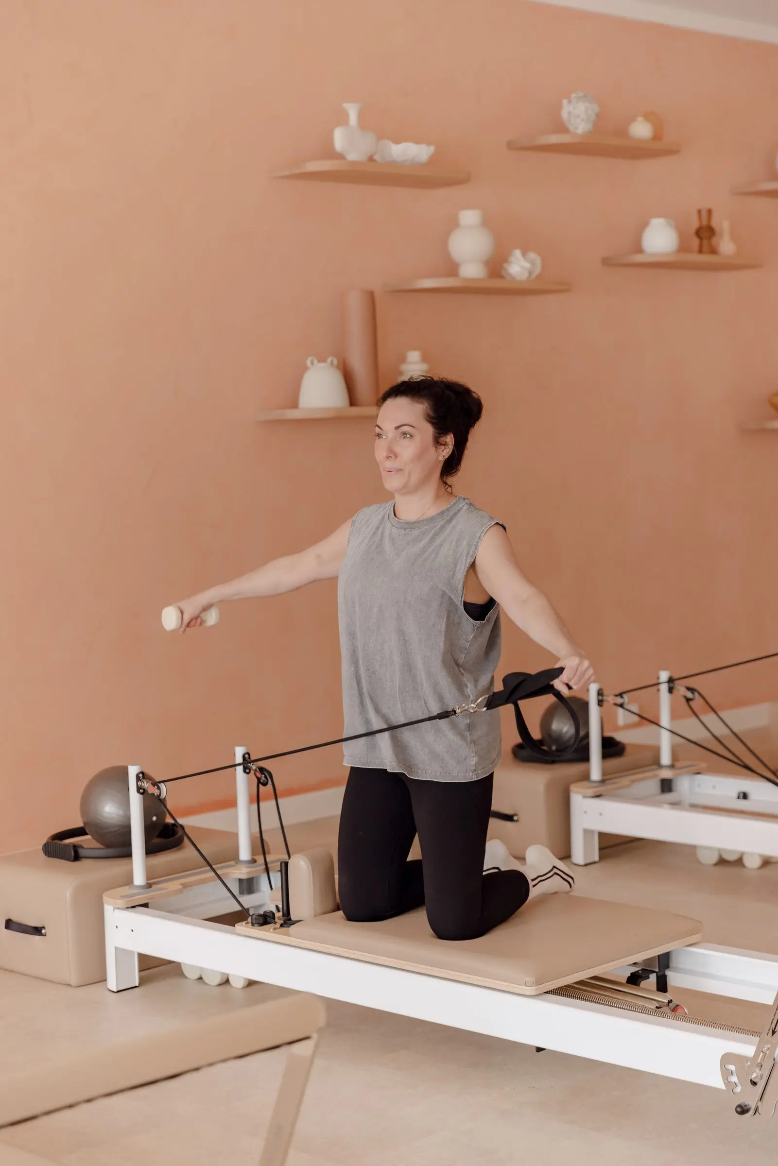 An instructor demonstrating on the reformer